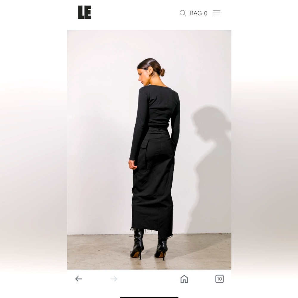 Black high waisted skirt with a slit down the side.